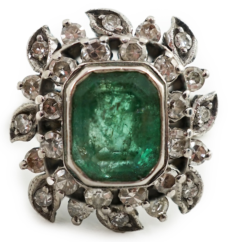 A 1960's white gold, emerald and diamond cluster set dress ring